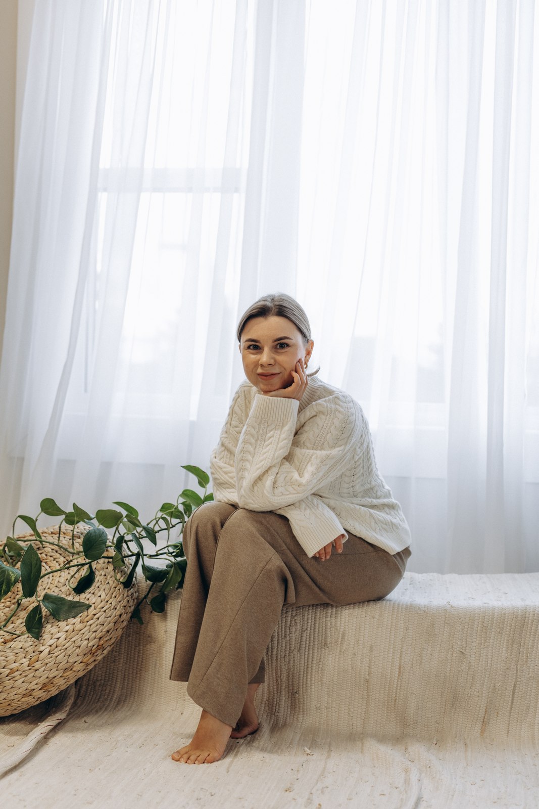 Anastasiia sitting in a bright studio